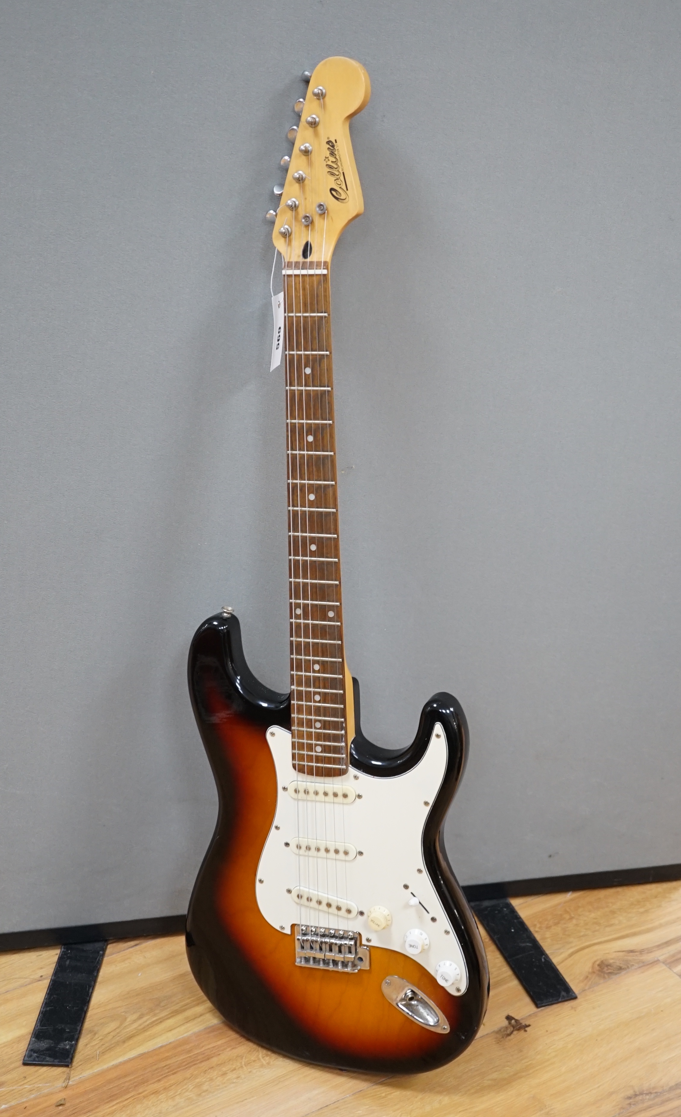 A Collins Sunburst electric guitar with hard flight case